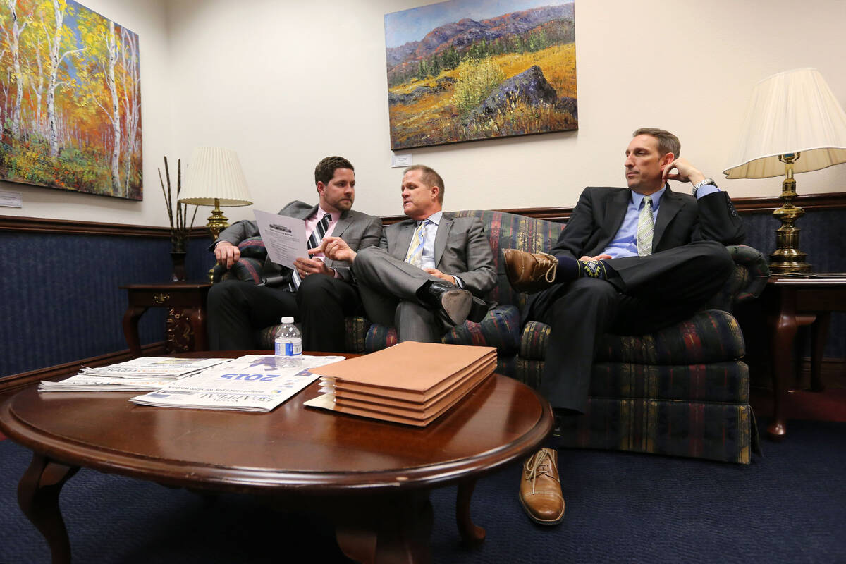 Lt. Gov. Mark Hutchison, center, and his chief of staff Ryan Cherry, left, talk with Sen. Scott ...