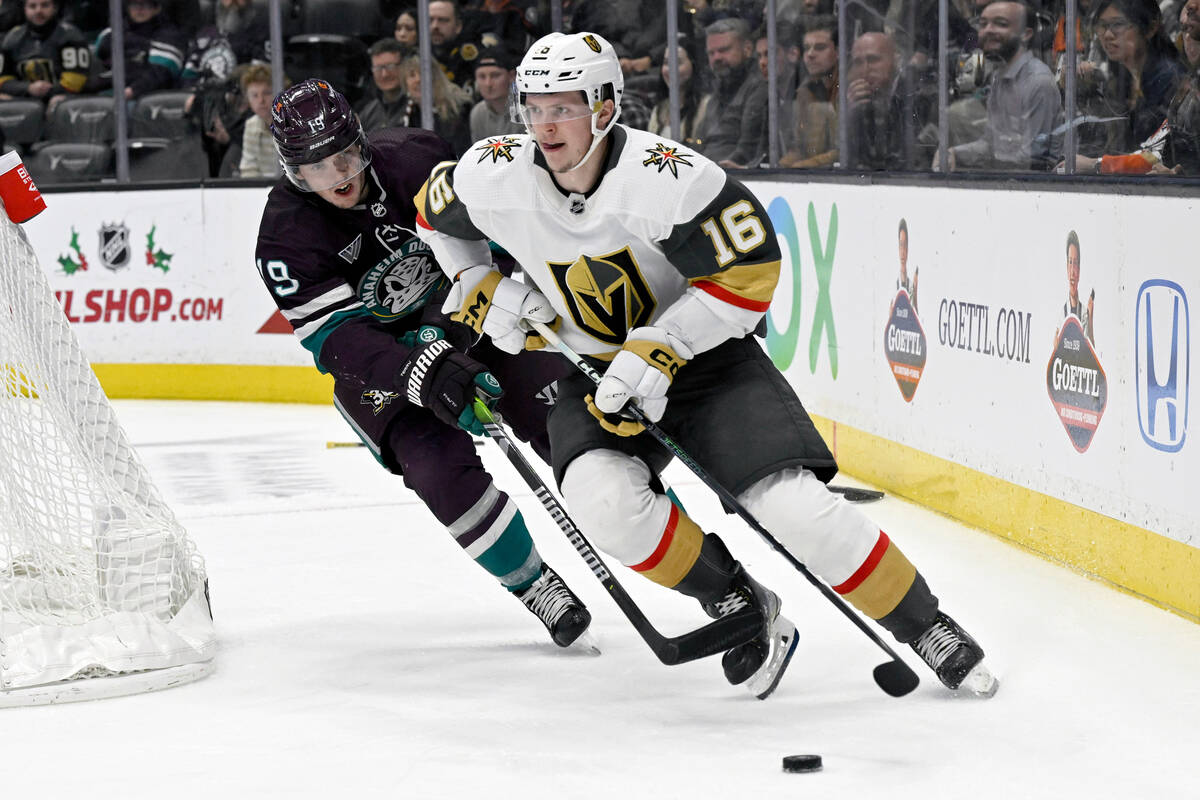 Vegas Golden Knights left wing Pavel Dorofeyev, right, controls the puck under pressure from An ...