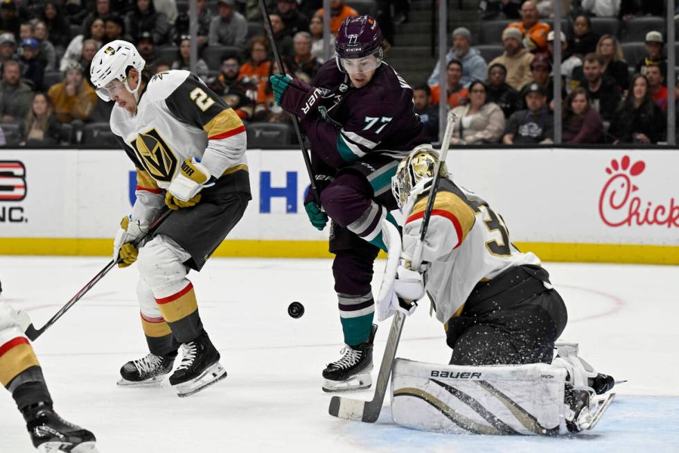 Vegas Golden Knights goaltender Logan Thompson, right, blocks a shot as Anaheim Ducks right win ...