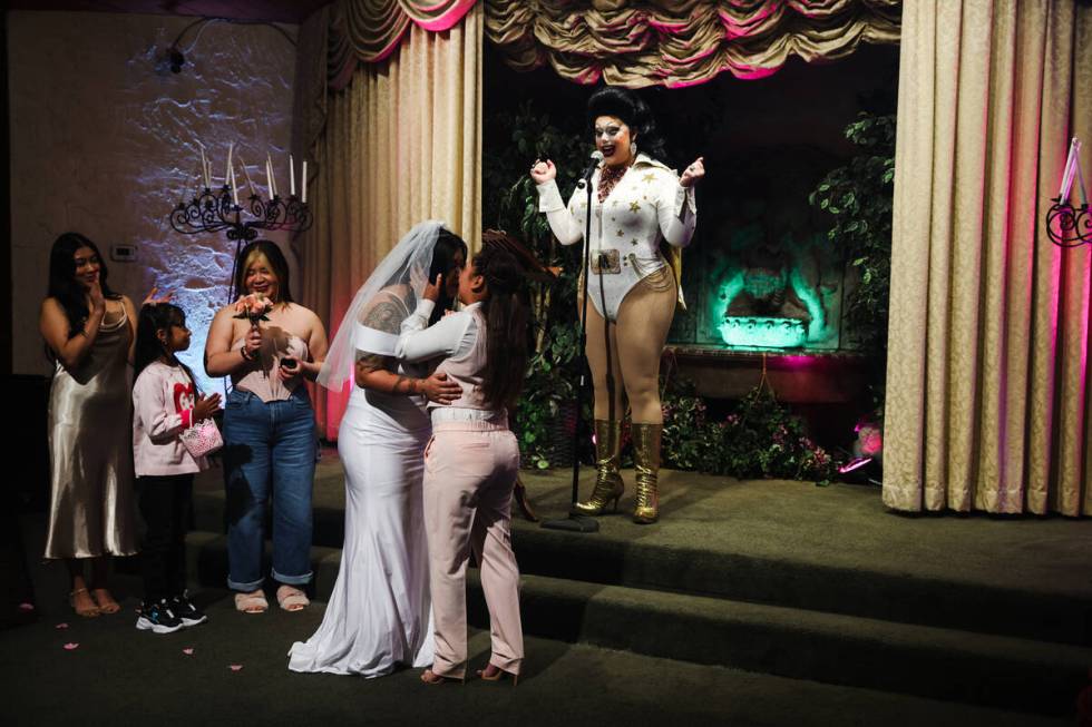 Martina “Sh-Elvis” Brookshire officiates the wedding of Michelle Antonio, left, a ...