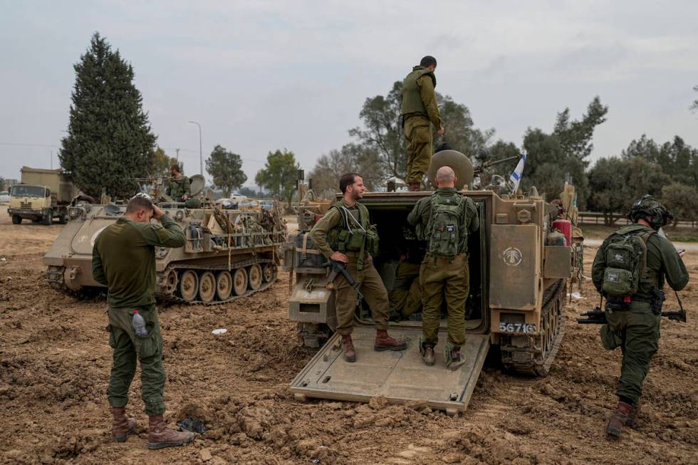 Israeli soldiers are seen at a staging area near the Israeli-Gaza border, in southern Israel, T ...