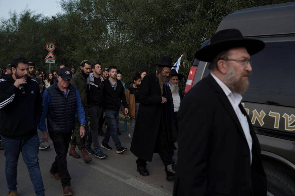 Relatives and friends of the Israeli Captain Neriya Zisk, follow his funeral procession as they ...