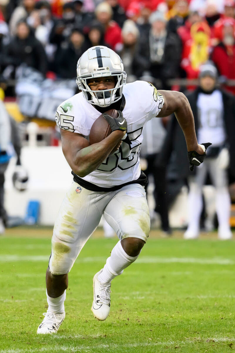 Las Vegas Raiders running back Zamir White carries the ball against the Kansas City Chiefs duri ...