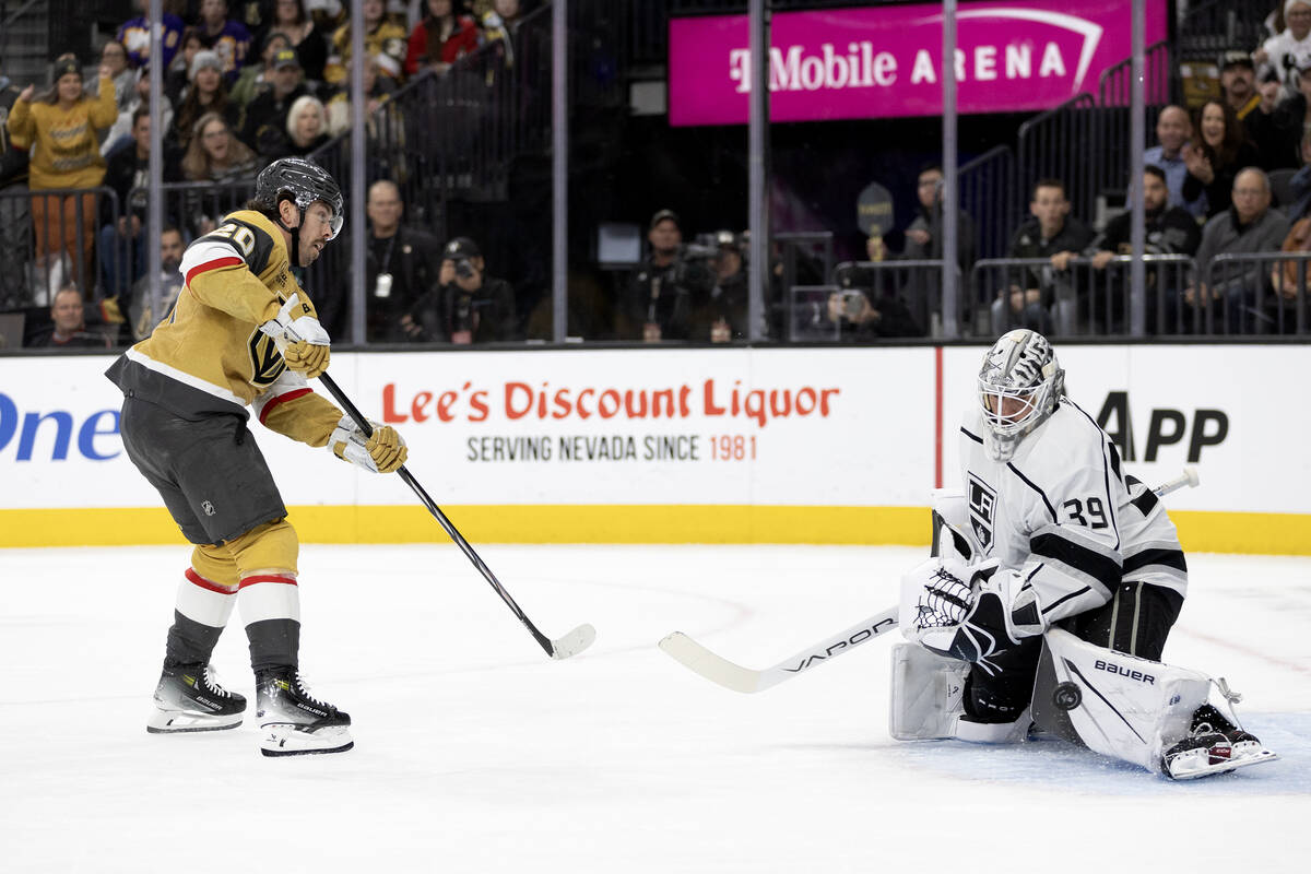 Golden Knights center Chandler Stephenson (20) watches his shot while Kings goaltender Cam Talb ...