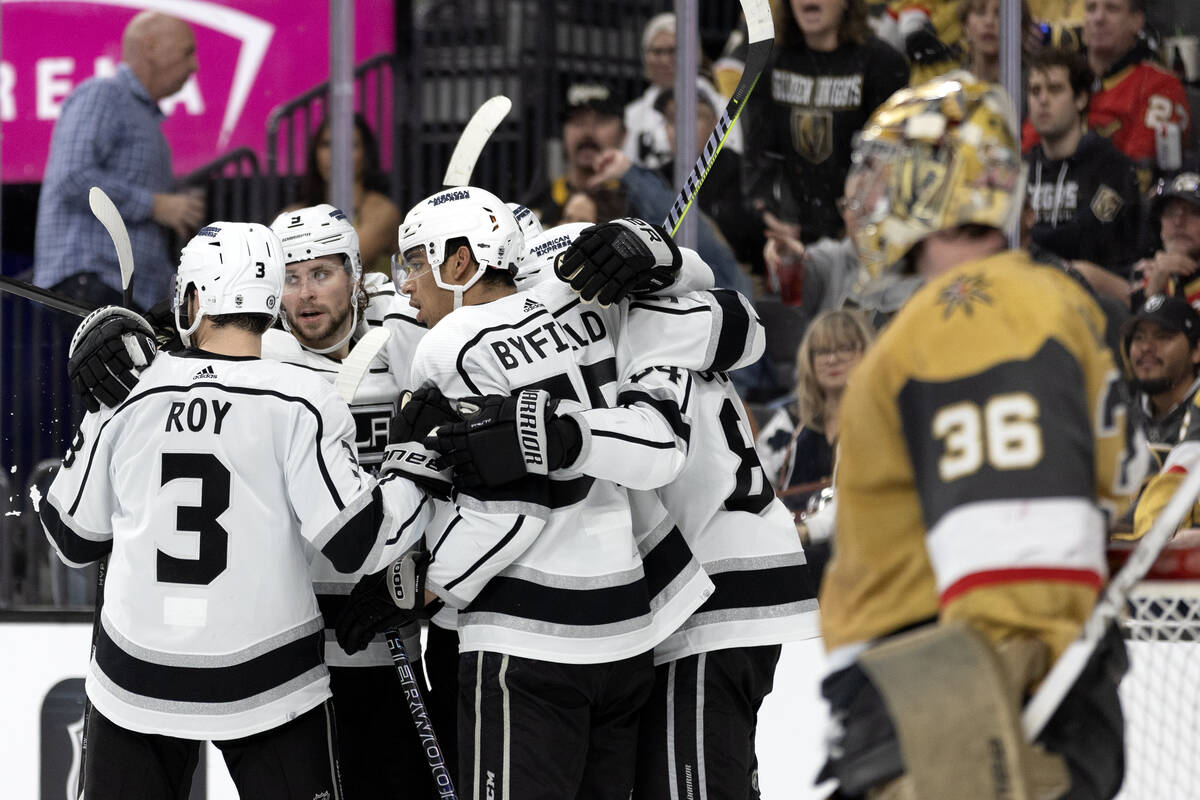 The Kings celebrate a goal while Golden Knights goaltender Logan Thompson (36) looks on during ...