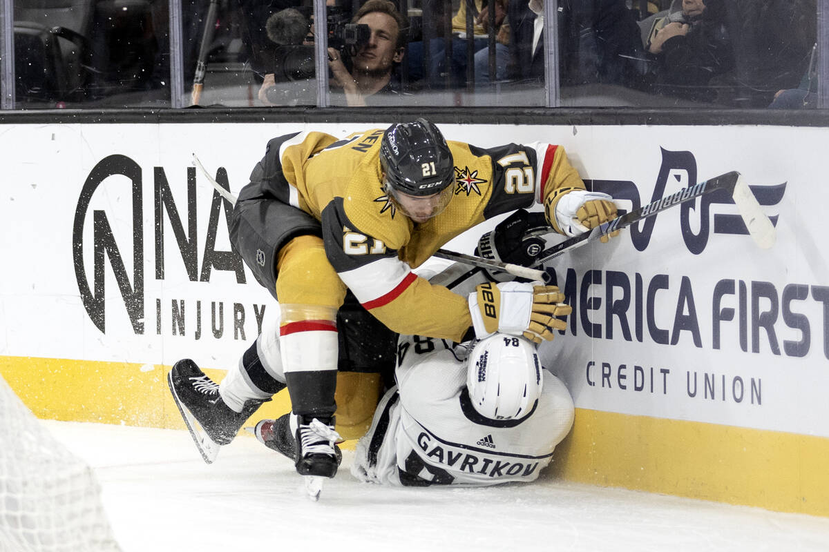 Golden Knights center Brett Howden (21) collides with Kings defenseman Vladislav Gavrikov (84) ...