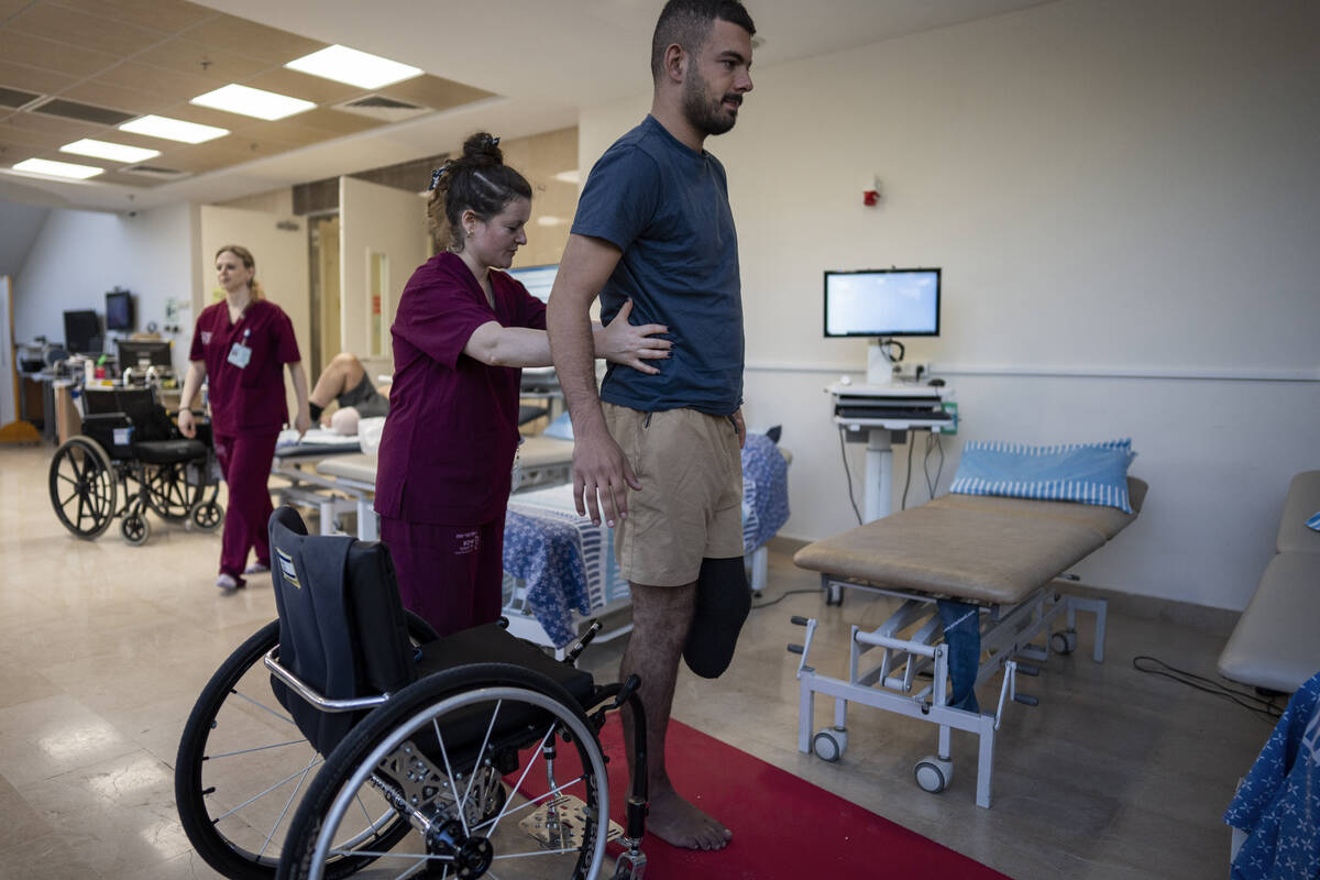 Israeli soldier Jonathan Ben Hamou, 22, wounded in the war with Hamas, practices standing durin ...