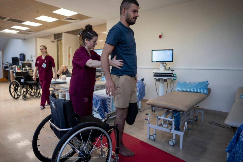 Israeli soldier Jonathan Ben Hamou, 22, wounded in the war with Hamas, practices standing durin ...