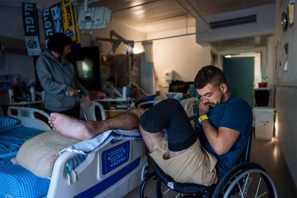 Israeli soldier Jonathan Ben Hamou, 22, wounded in the war with Hamas, sits in his room at Sheb ...