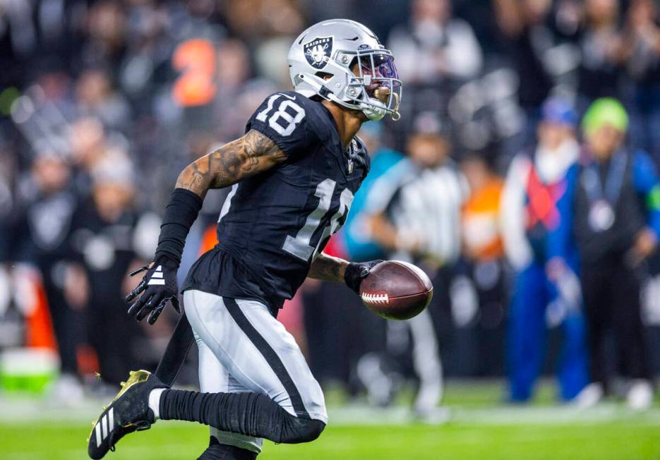 Raiders cornerback Jack Jones (18) runs in an interception against the Los Angeles Chargers for ...