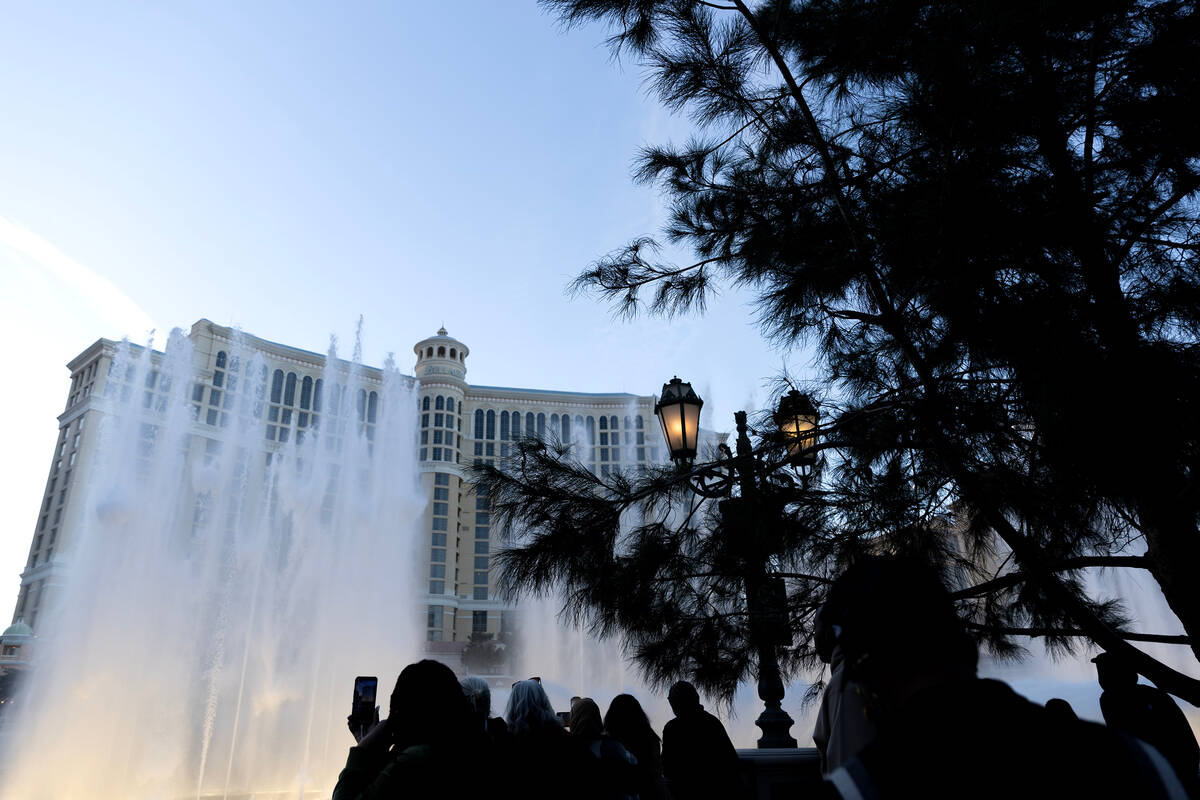 Groups photograph and record the Bellagio Fountain show on Friday, Dec. 29, 2023, on the Las Ve ...