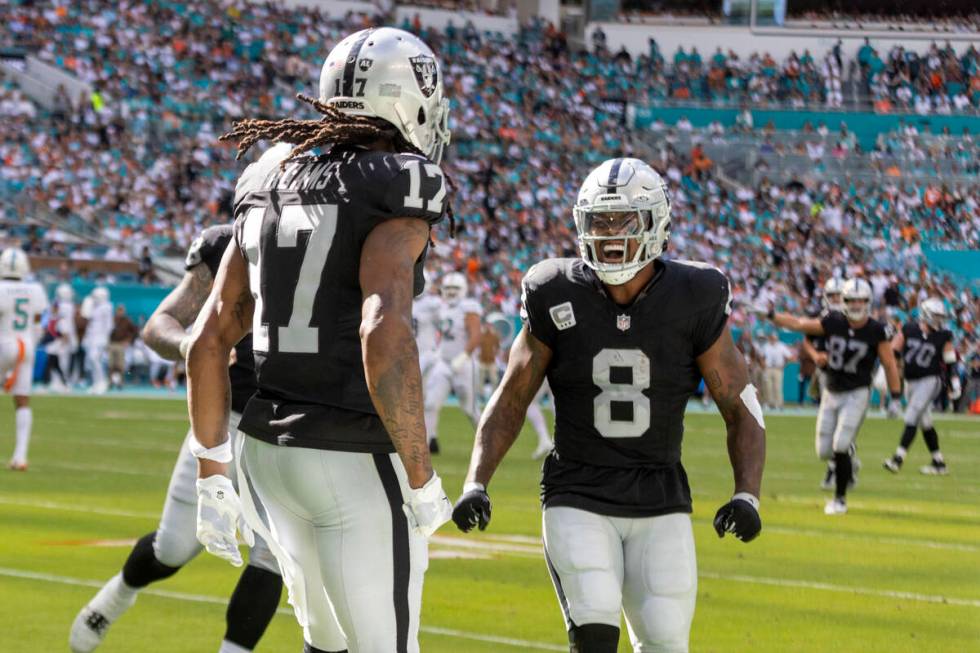 Raiders running back Josh Jacobs (8) celebrates wide receiver Davante Adams’ (17) touchd ...