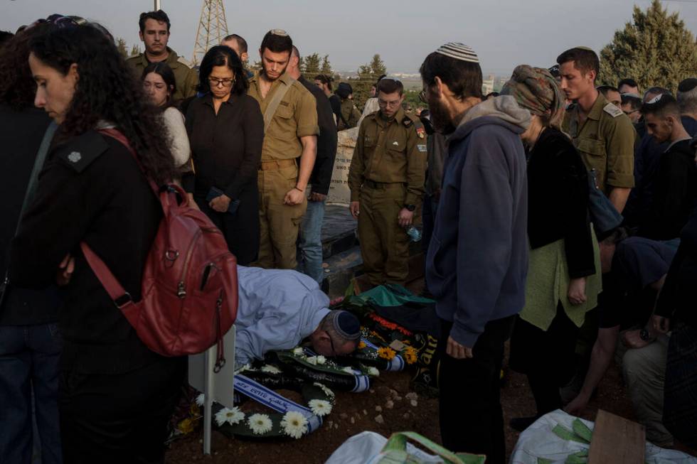 Relatives and friends mourn during the funeral of the Israeli Captain Neriya Zisk, at a cemeter ...