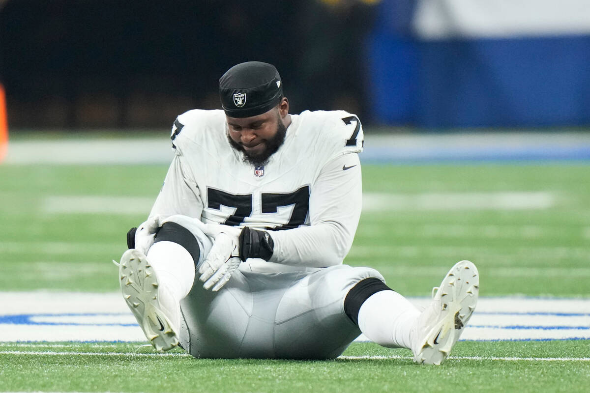 Las Vegas Raiders offensive tackle Thayer Munford Jr. (77) goes down with an injury during the ...