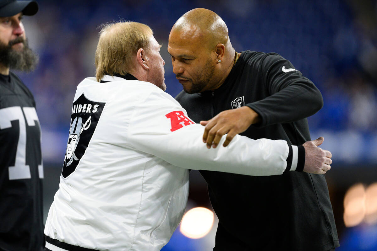 Las Vegas Raiders interim head coach Antonio Pierce and Las Vegas Raiders owner Mark Davis hug ...