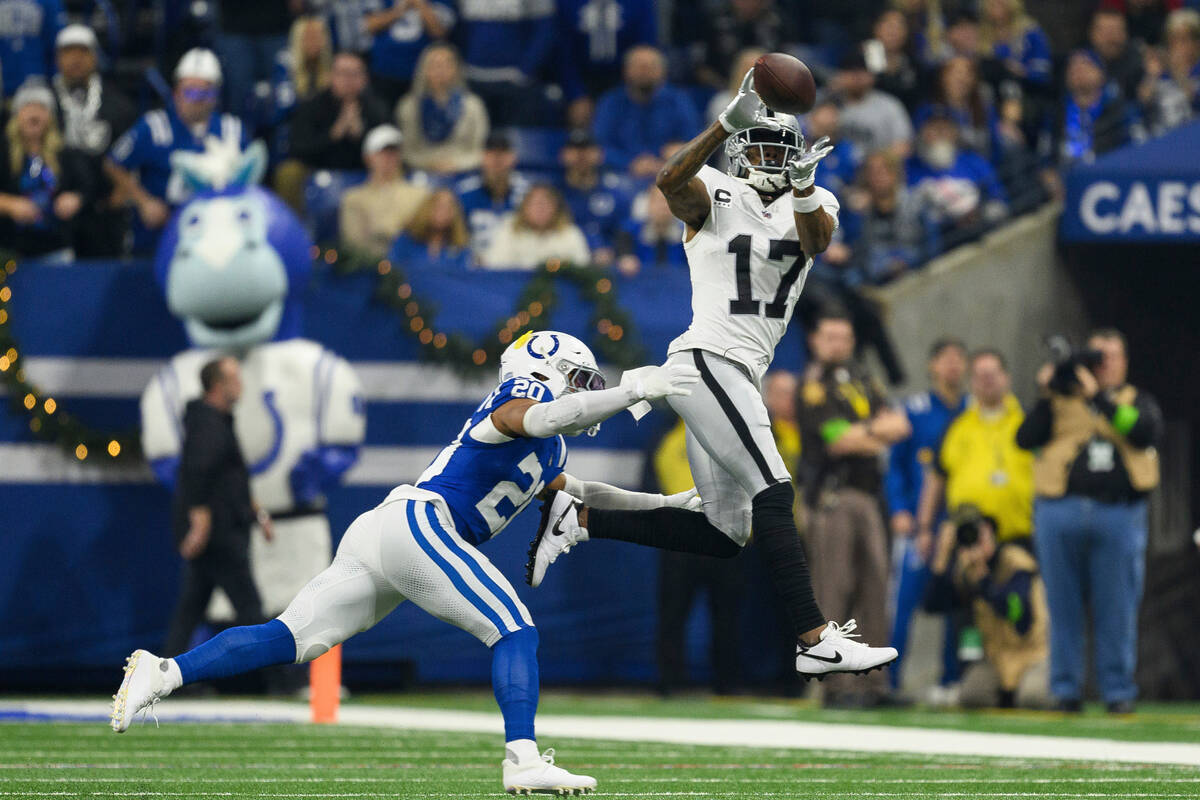 Las Vegas Raiders wide receiver Davante Adams (17) catches a pass as Indianapolis Colts safety ...