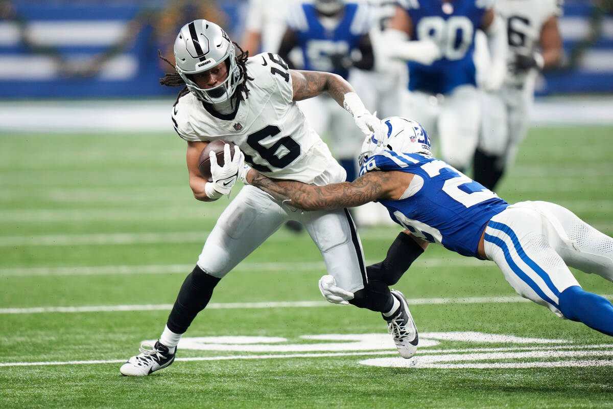Las Vegas Raiders wide receiver Jakobi Meyers (16) is tackled by Indianapolis Colts cornerback ...