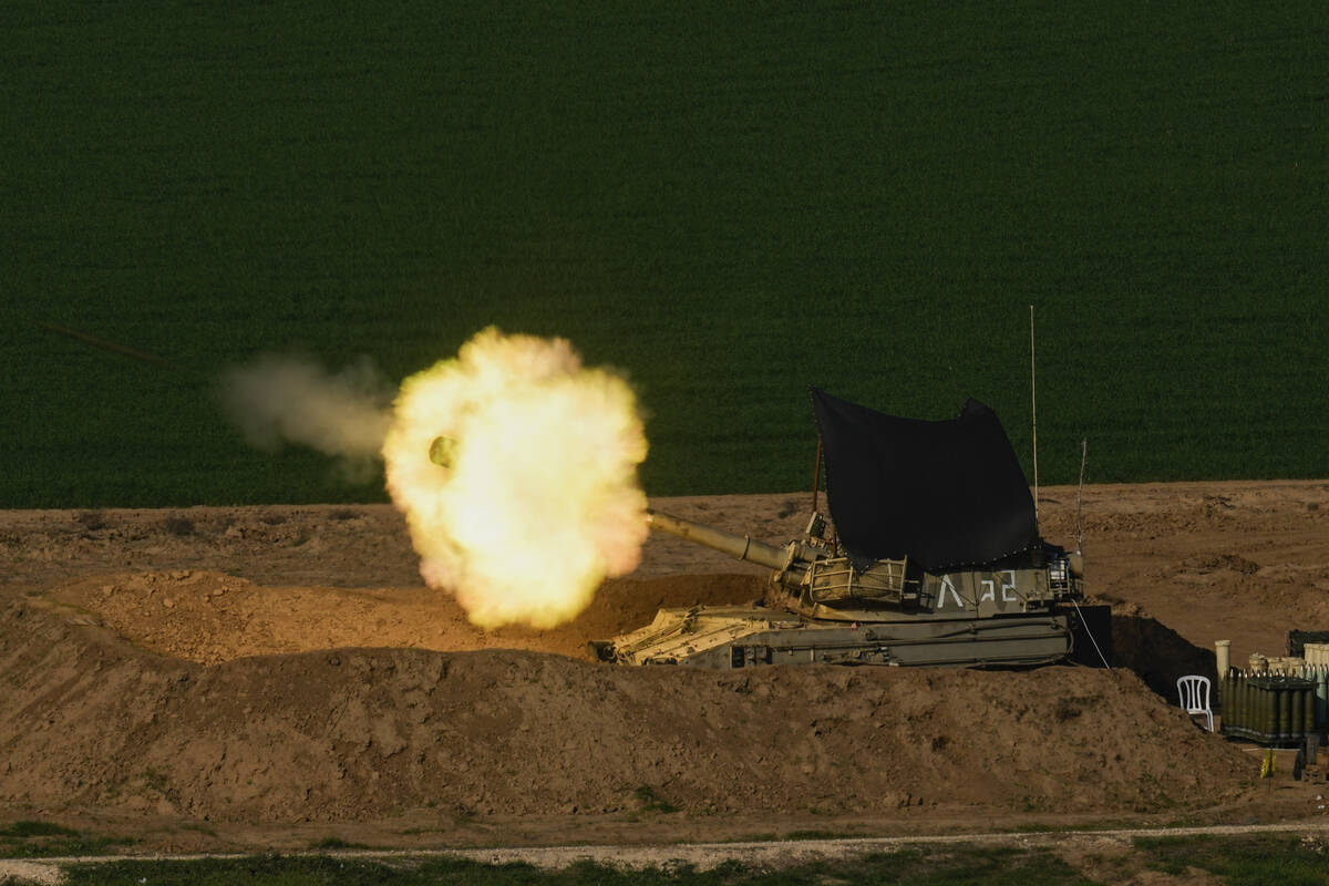 An Israeli mobile artillery unit fires a shell from southern Israel towards the Gaza Strip, in ...