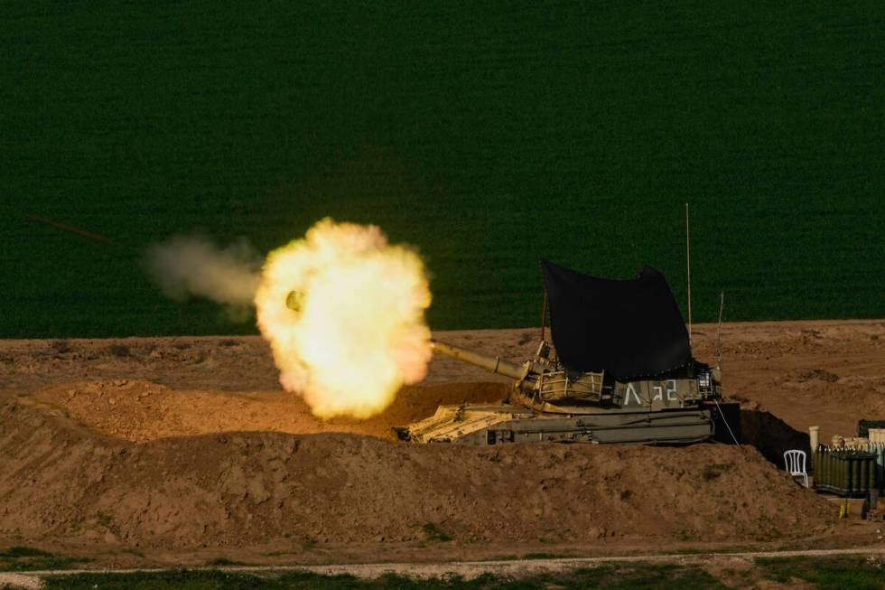 An Israeli mobile artillery unit fires a shell from southern Israel towards the Gaza Strip, in ...