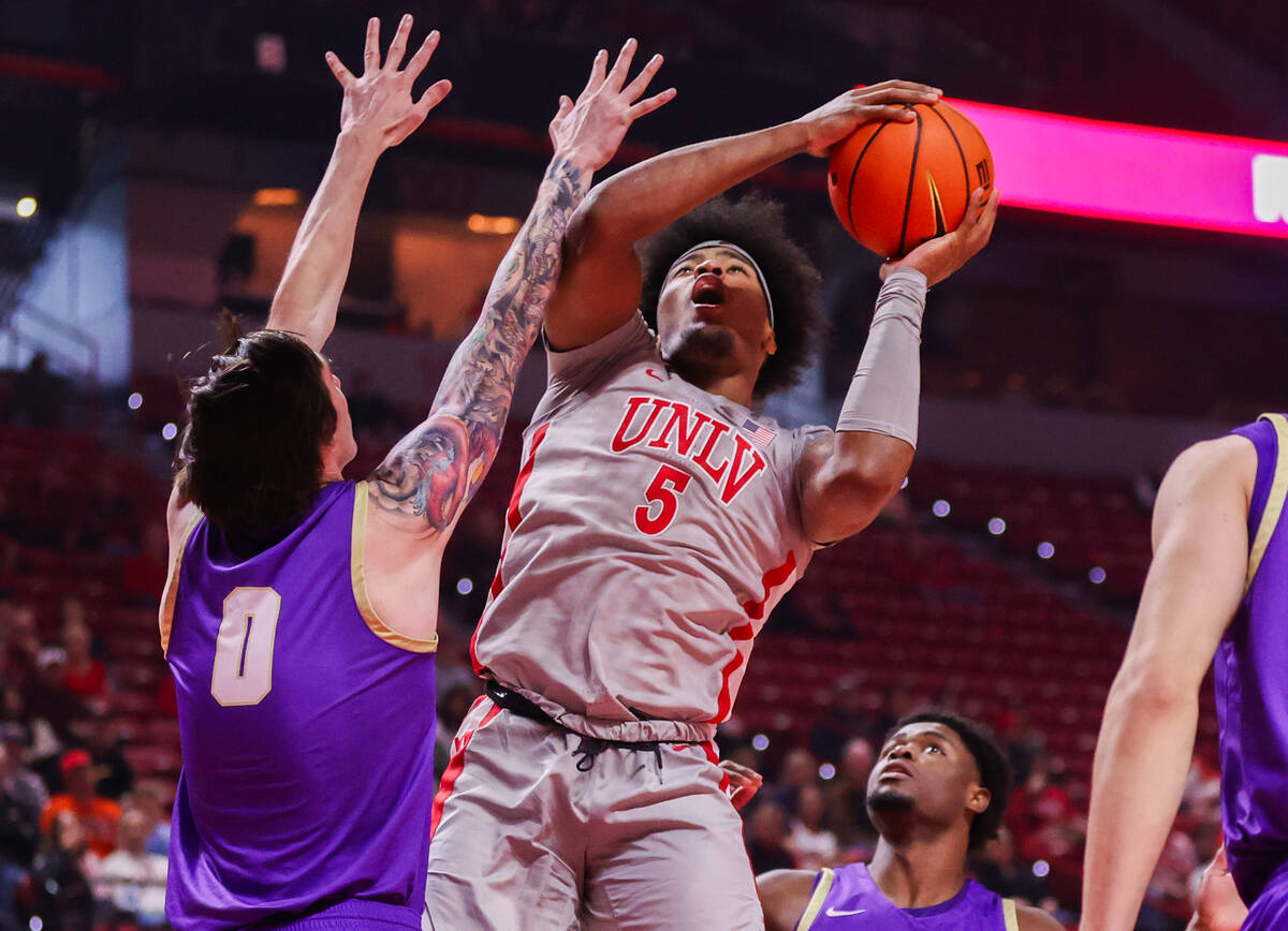 UNLV Rebels forward Rob Whaley Jr. (5) goes in for a layup around Carroll College Fighting Sain ...