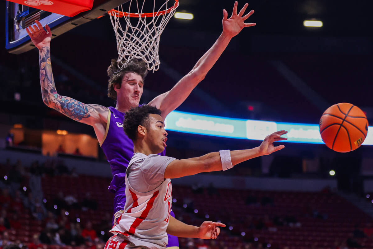 UNLV Rebels guard Dedan Thomas Jr. (11) passes the ball as Carroll College Fighting Saints cent ...