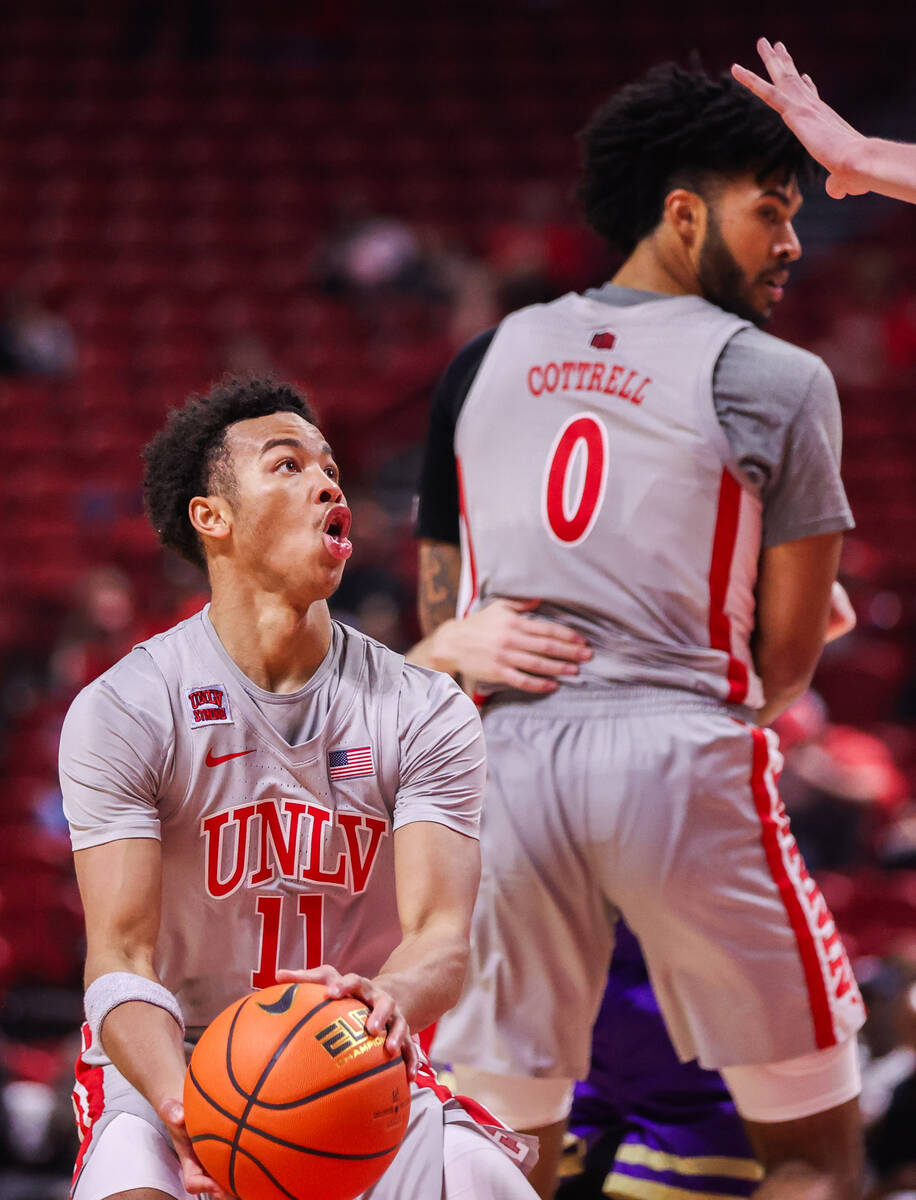 UNLV Rebels guard Dedan Thomas Jr. (11) looks up to the basket during a college basketball game ...