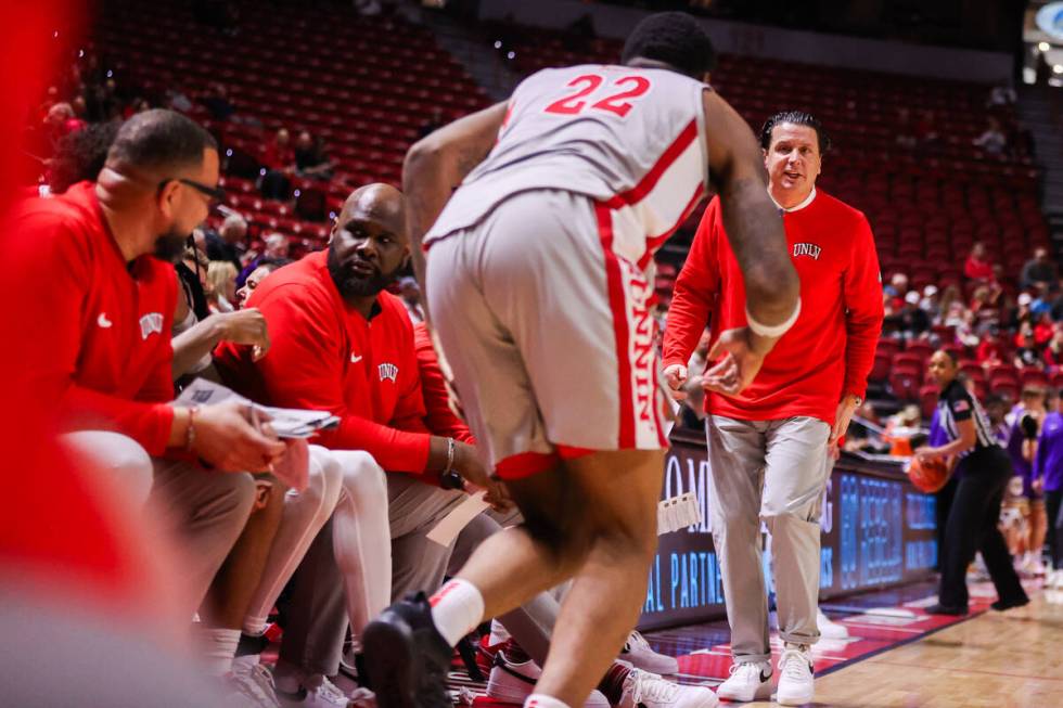 UNLV Assistant Coach Barret Peery prepares to bring in UNLV Rebels forward Karl Jones (22) duri ...