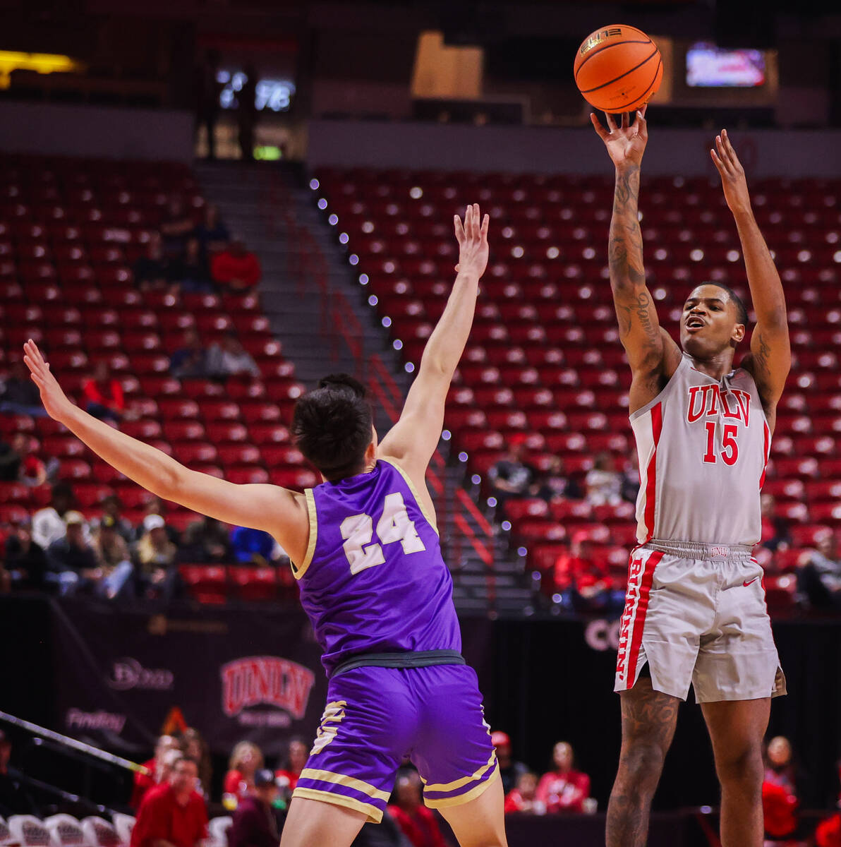 UNLV Rebels guard Luis Rodriguez (15) shoots a three pointer against Carroll College Fighting S ...