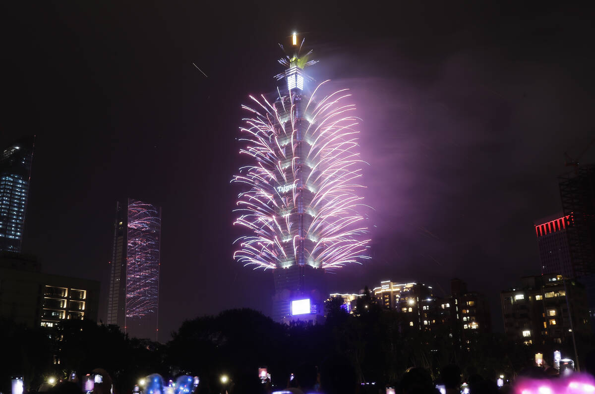 Fireworks explode at the Taipei 101 building during the New Year's celebrations in Taipei, Taiw ...