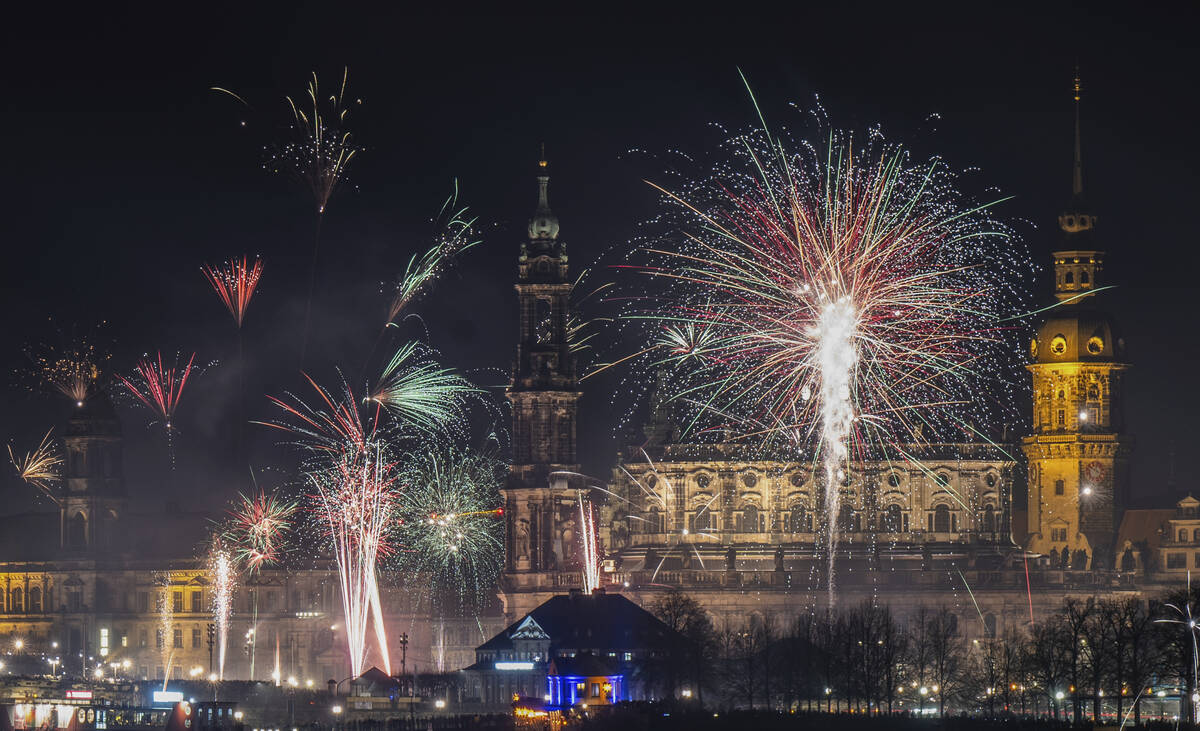 Fireworks explode over the historic Old Town backdrop on the Elbe in Dresden, Germany, on Sunda ...