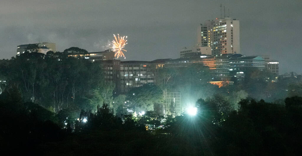Fireworks explode over the city during New Year's celebrations in Nairobi, Kenya, Monday, Jan. ...