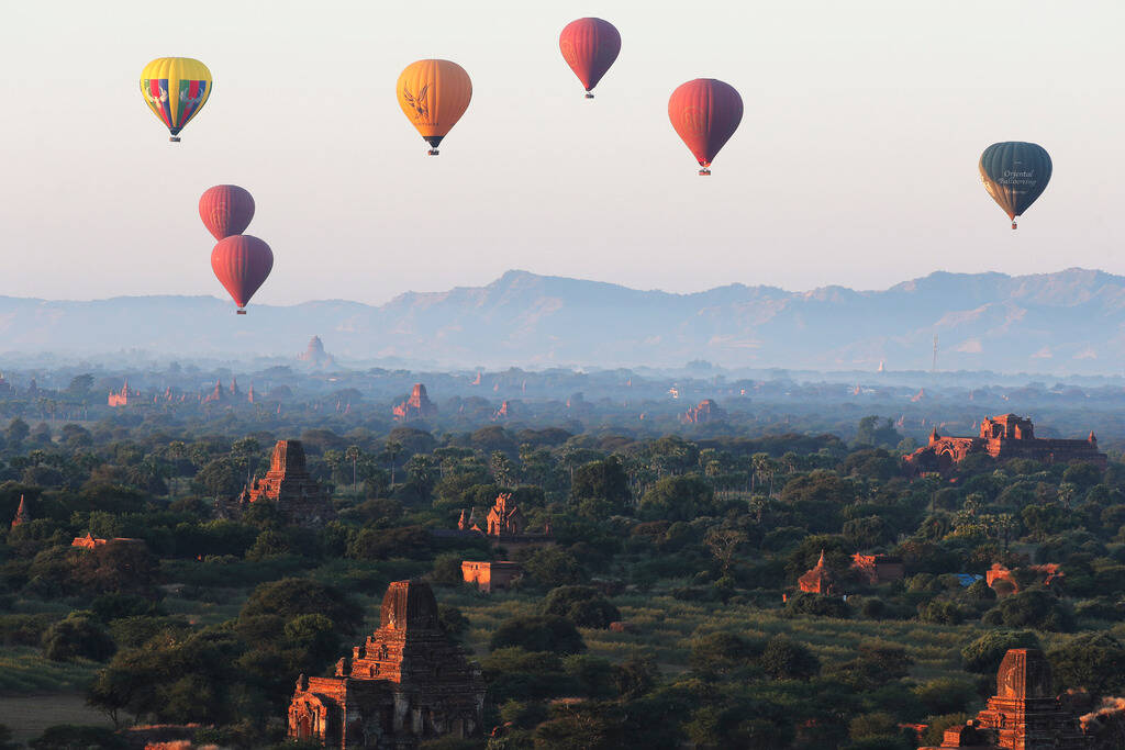 Hot air balloons fly over Myanmar's ancient temples just before the sunrise on New Year's Day i ...
