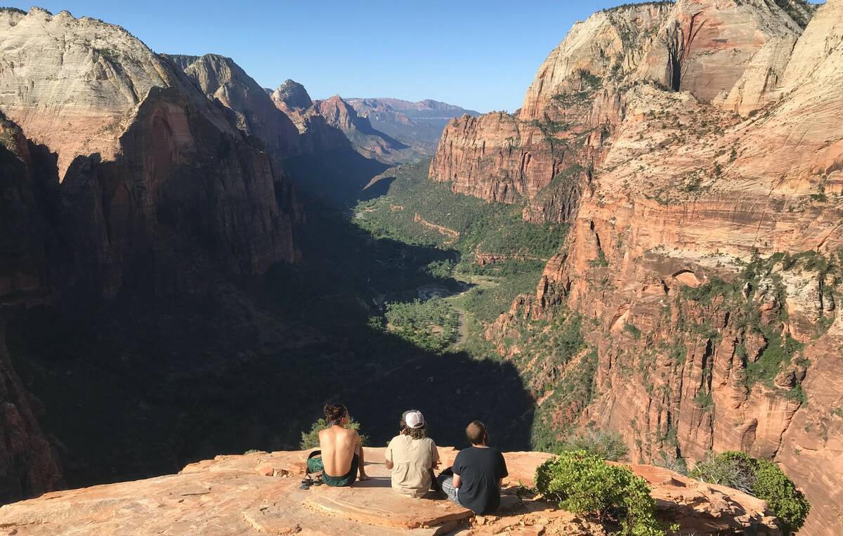 A trio of hikers take in the view from the top of Angels Landing in Zion National Park June 4, ...