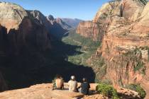 A trio of hikers take in the view from the top of Angels Landing in Zion National Park June 4, ...