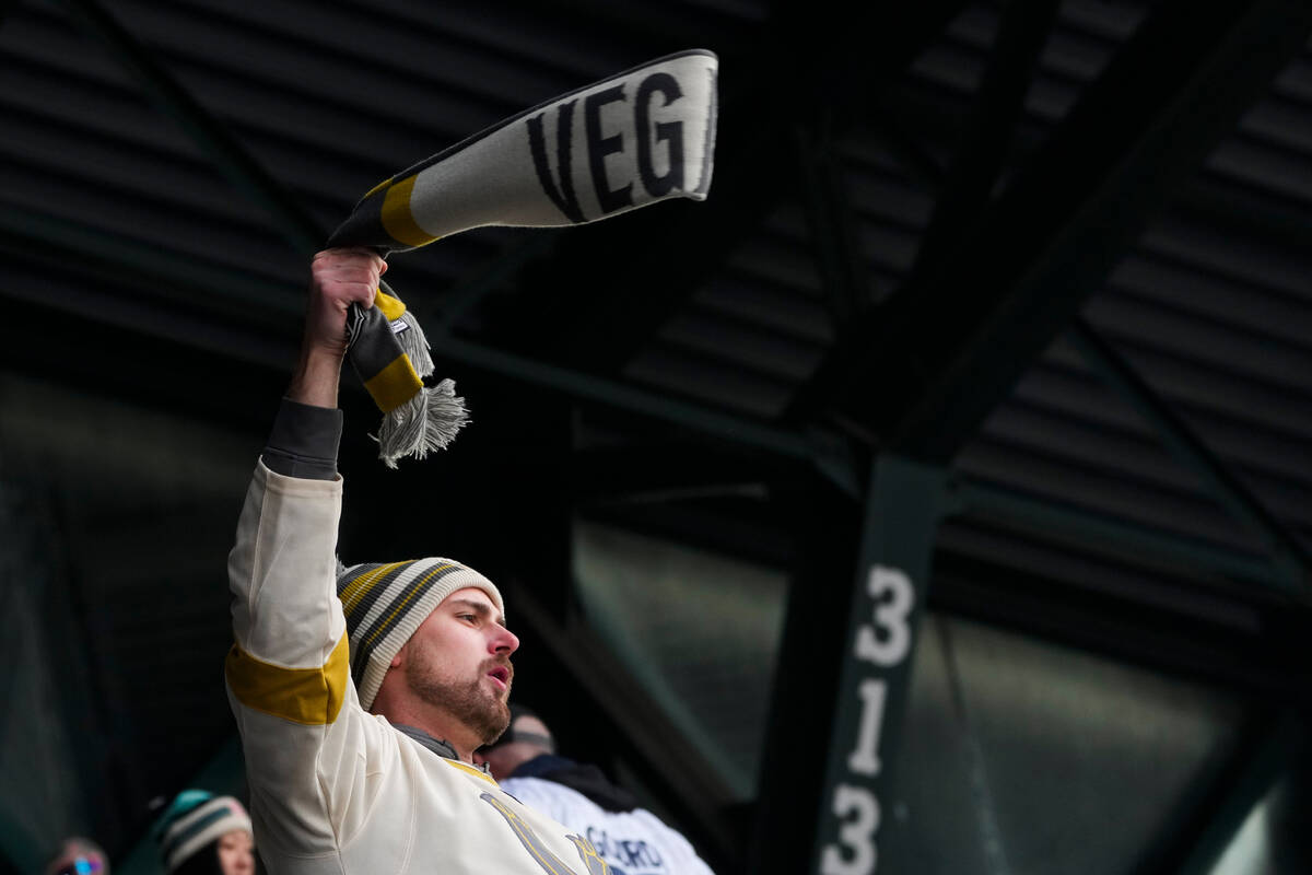 A fan waves a Vegas Golden Knights scarf during the second period of the NHL Winter Classic hoc ...