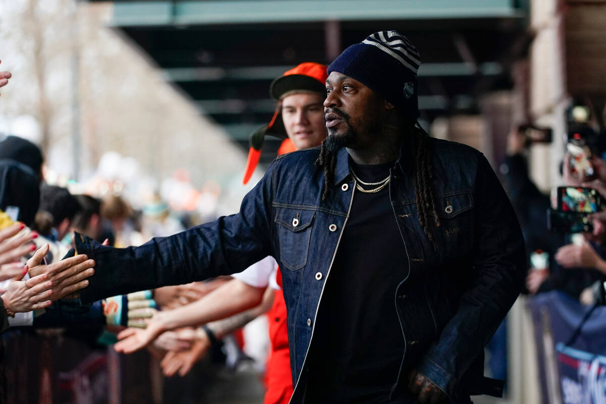 Former Seattle Seahawks running back Marshawn Lynch greets fans as he arrivers with the Seattle ...