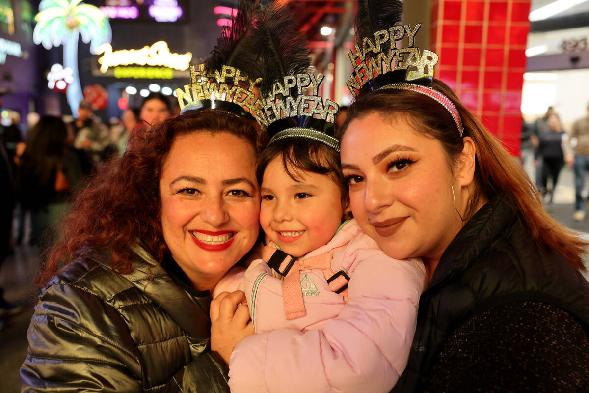 New Year’s Eve revelers Erica Ramos and her daughters Jennifer Almanza, 27, and Victoria ...