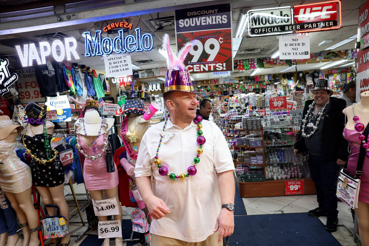 Cashier Tim Mac Lean of Western Village One Stop looks for New Year’s Eve revelers durin ...