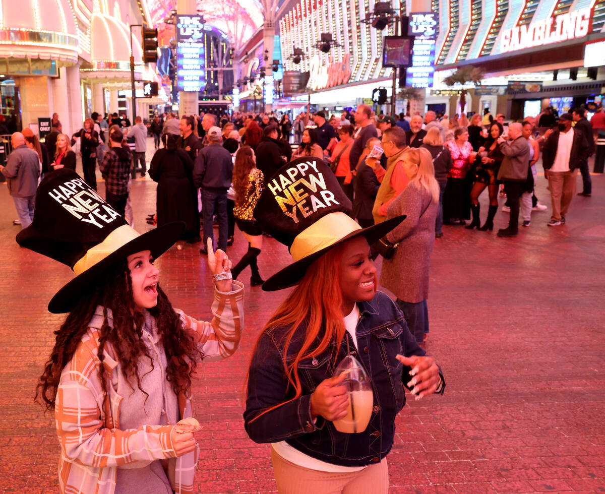 New Year’s Eve revelers Nichole Shivers, 25, left, and Tianna McHenry, 27, celebrate dur ...