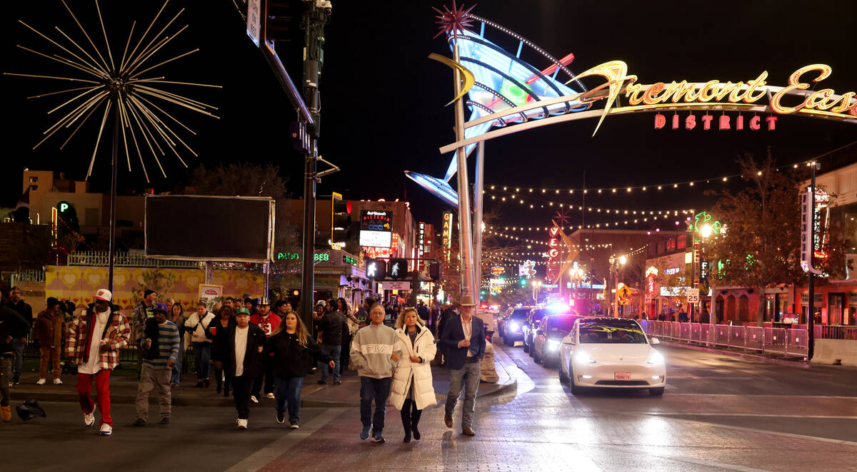 New Year’s Eve revelers make their way across Las Vegas Boulevard to the Time of Your Li ...