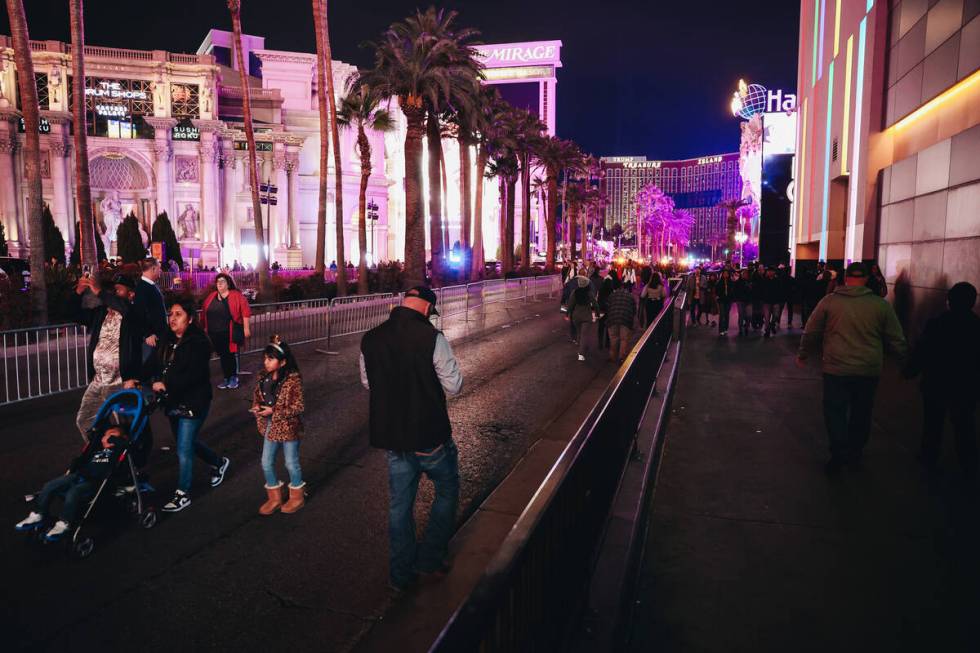 People walk throughout the streets on the Strip after they were closed off for New Year’ ...