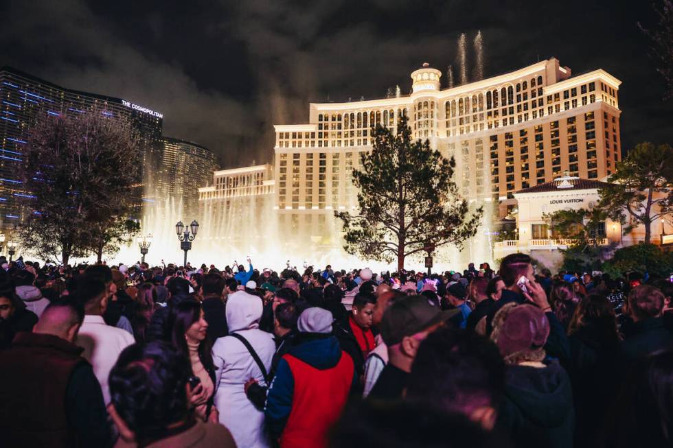 Crowds gather in front of the Fountains of Bellagio shortly before midnight on Sunday, Dec. 31, ...