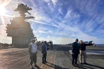 Defense Secretary Lloyd Austin, second right, talks with the commanding officer of the USS Gera ...