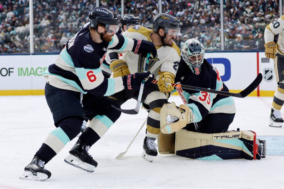 Vegas Golden Knights left wing William Carrier (28) tries to work his way past Seattle Kraken d ...