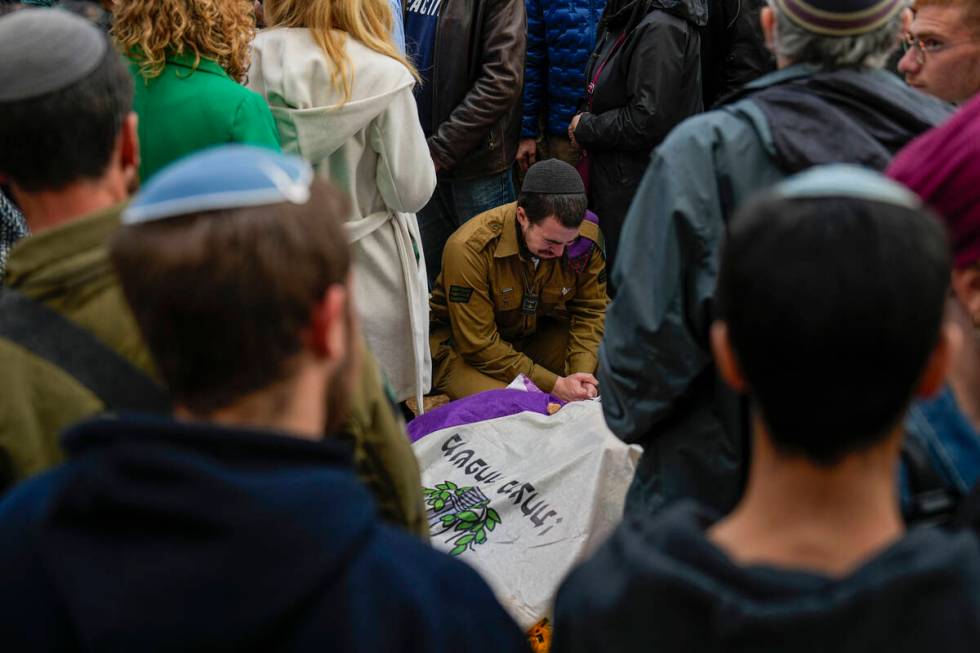 Mourners gather in grief around the grave of American-Israeli reserve solider Sgt. 1st Class Am ...