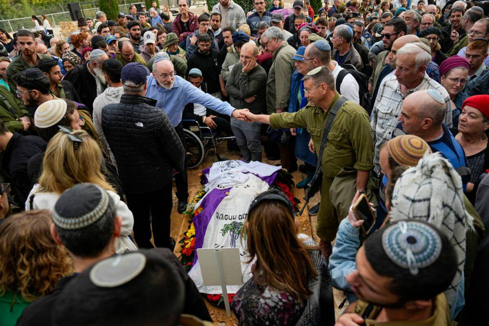 Mourners gather in grief around the grave of American-Israeli reserve solider Sgt. 1st Class Am ...