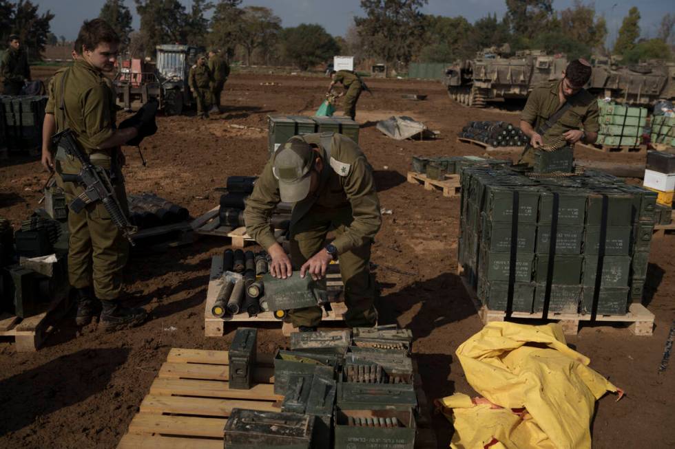 Israeli soldiers store ammunition in a staging area at the Israeli-Gaza border in southern Isra ...