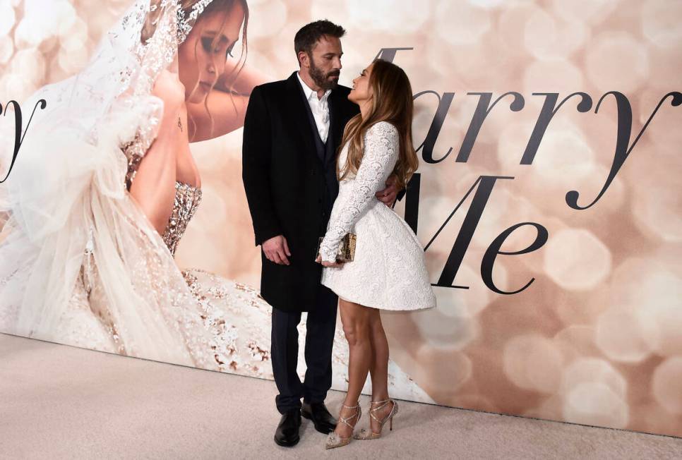 Jennifer Lopez, right, and Ben Affleck attend a photo call for a special screening of "Marry Me ...