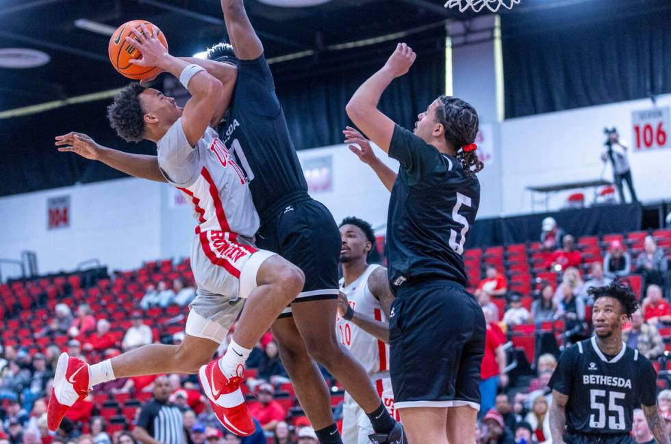 UNLV Rebels guard Dedan Thomas Jr. (11) battles to get off a shot against Bethesda University F ...