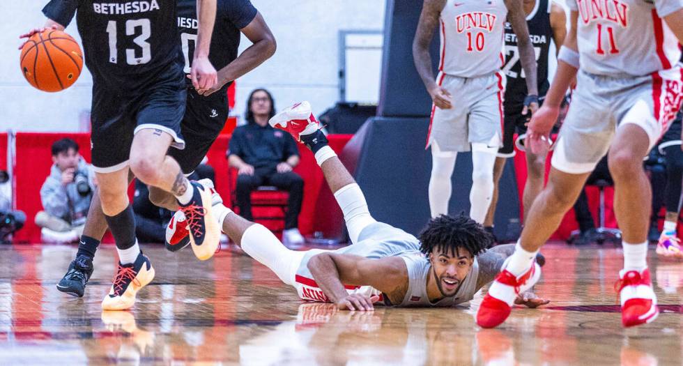 UNLV Rebels forward Isaiah Cottrell (0) looks to Bethesda University Flames guard Michael Pluml ...